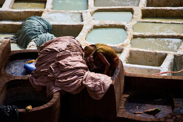 People works in the Shuara leather dyeing factory. Traditional Moroccan craft.