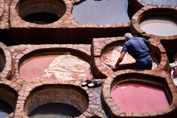 People works in the Shuara leather dyeing factory. Traditional Moroccan craft.