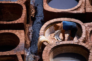 People works in the Shuara leather dyeing factory. Traditional Moroccan craft.