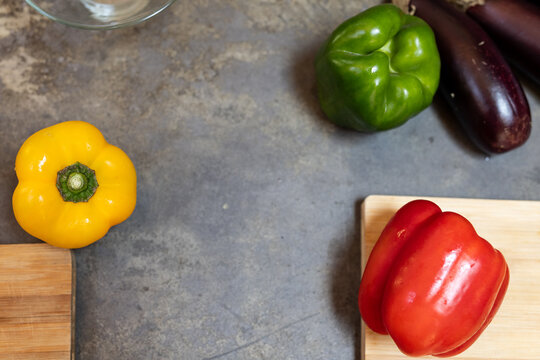 Colorful bell peppers and eggplants on kitchen counter for Thanksgiving cooking, at home, copy space