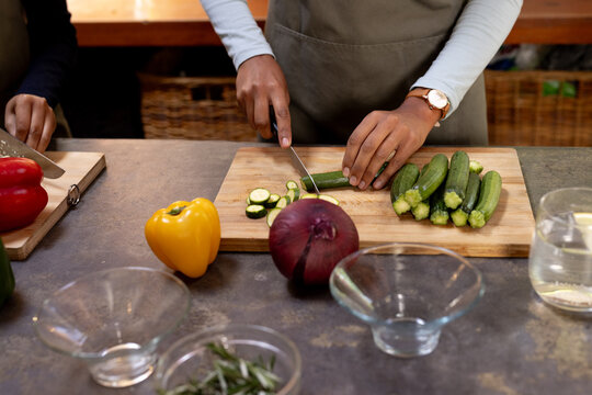 Woman chopping colorful vegetables in kitchen for thanksgiving dinner preparation, at home