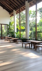 Spacious, light-filled lounge area with wooden furniture and large windows overlooking a lush green garden.