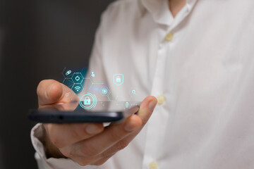 Businessman using smart phone with social media icons on the screen.