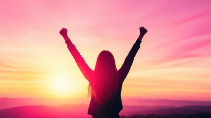 woman celebrating at sunset with raised arms, expressing joy and freedom. vibrant colors of sky create beautiful backdrop
