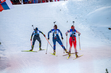 Biathlon athletes on the snowy track while winter sport professional race