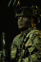Portrait of Soldier in Tactical Gear with Night Vision Goggles and Rifle