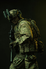 Side Profile of Soldier in Tactical Gear with Rifle and Night Vision Goggles