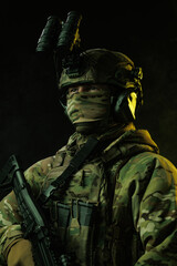 Portrait of Soldier in Tactical Gear with Night Vision Goggles and Rifle
