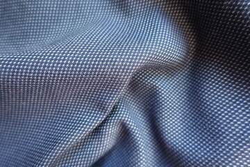 striped cotton fabric in shades of blue in soft folds