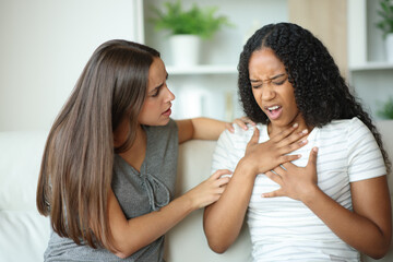 Scared woman helping her friend choking
