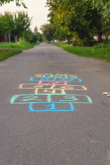 Children jumping hopscotch on the street. Selective focus.