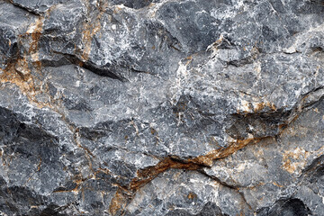 Textured gray rock surface showing mineral veins in natural formation
