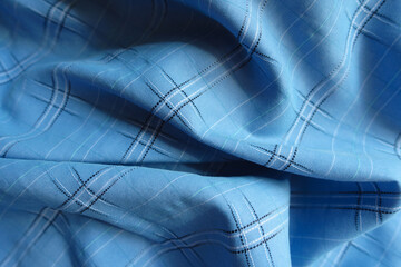 Folded bright sky blue checkered modal fabric