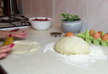 Making dumpling. Rolling dough with rolling pin.Jiaozi preparation.