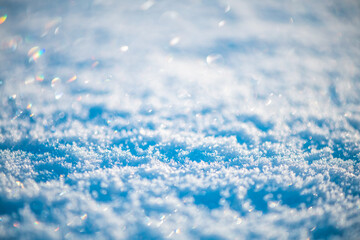 Natural snow background, snow glitters and shimmers like a rainbow in the sun, natural snow texture