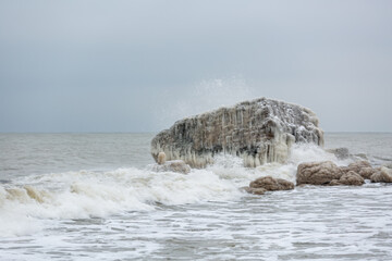 Icy building constructions in sea in winter