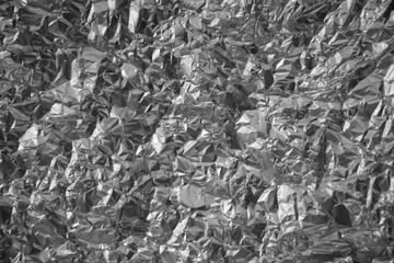 Processed collage of shiny metal silver gray foil crumpled packaging material texture