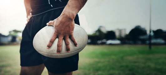 Rugby, sports and hands of man with ball on field for training, tournament match and game. Closeup, athlete and player ready for exercise, workout and fitness for practice, performance or competition