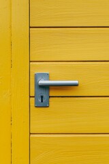 A yellow door with a silver handle, close-up, in a simple, minimalistic style