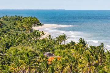 TRANCOSO, BAHIA STATE, BRAZIL: aerial view, tourists enjoying perfect tropical beach with white sand, palm trees, turquoise water and small waves, near Porto Seguro © Pvince73