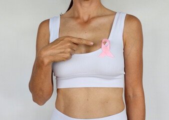 Woman hand holding pink ribbon breast cancer awareness