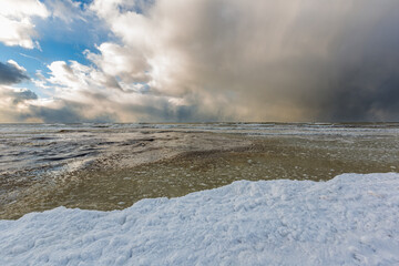 Wonderfully beautiful sunset by the sea in winter with ice