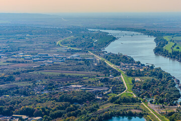 Aerial view of valley with farm fields, pond and Danube river. High quality photo