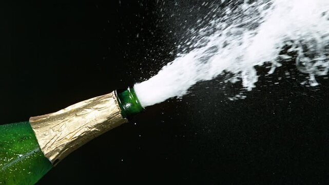 Super slow motion of Champagne explosion with flying cork closure, opening champagne bottle closeup. Filmed on high speed cinematic camera at 1000 frames per second.