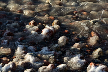 Wonderfully beautiful sunset by the sea in winter with ice
