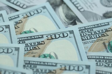 Many hundred dollar bills new banknotes in big pile under the natural light