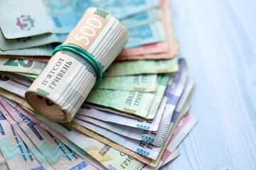 Big amount of different ukrainian hryvnia currency money bills on wooden background