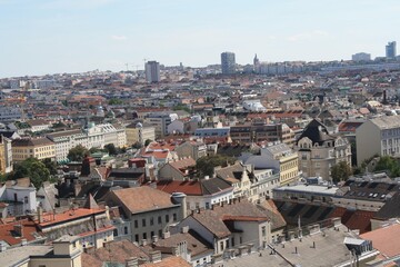 A panoramic view of the urban landscape in Vienna showcasing rooftops and modern architecture on a sunny day