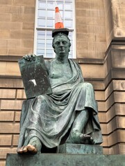 Statue of a man in a suit with a fountain