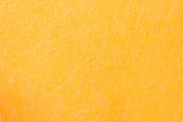Fototapeta premium Yellow sponge texture background, close-up. Shiny soft sponge, top view