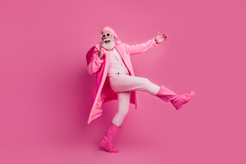 Full size photo of eccentric excited aged man carry gift bag wear bathrobe boots walk isolated on pink color background