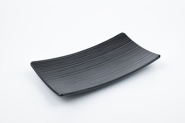 Empty black Japanese Ceramic square plate isolated on a white background