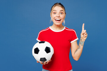 Young woman fan wear basic red t-shirt cheer up support football sport team hold in hand soccer...
