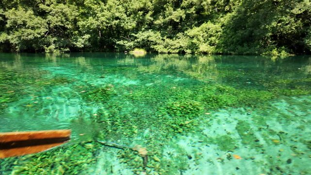 Sunlight reflecting on the crystal clear turquoise water of Black Drin springs in lake Ohrid, north Macedonia, creating a mesmerizing spectacle of light and shadow