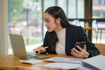 Asian businesswoman working with a laptop at the office.