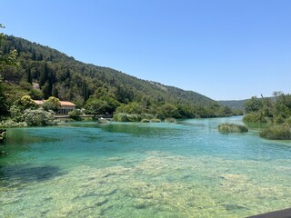 Tranquil River Scene with Crystal Clear Waters and Lush Green Hills