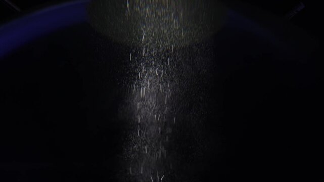 A beam of soft light filters down through darkness, illuminating tiny particles that float gently within it. The scene has a peaceful, ethereal quality, evoking a sense of transcendence or a journey t
