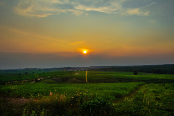 Fototapeta premium sunset on farmland, nature horizon, Golden hour
