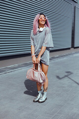 Young beauty girl purple hair make selfie on smartphone, happy face, outdoor hipster portrait on the street, smile happy face, listen music on headphones, Amsterdam street, dance, player,photo concept