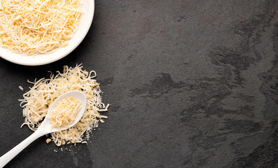 Coconut chunks with sugar in bowl and spoon - Organic grated cocos nucifera.