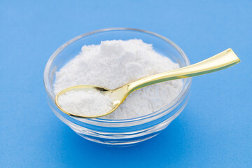 Baking soda powder in spoon and bowl - Healthy food.