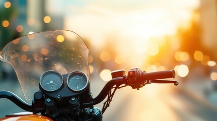 A close-up view of a motorcycle's dashboard with a windshield, set against a backdrop of glowing city lights at sunset, conveys a sense of freedom and motion.