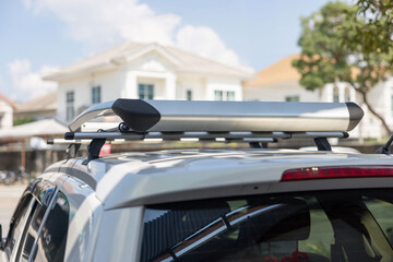 Fototapeta premium A white car with a roof rack on top