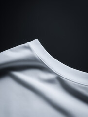 Fototapeta premium Detailed 3D render of a folded white t-shirt on a black background, highlighting the material texture and fine stitching along the collar.