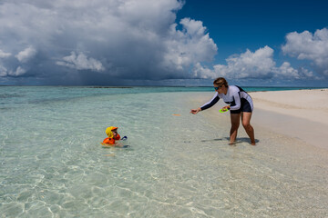 Obraz premium A family is playing on the bikini beach of Mathiveri island of the Maldives