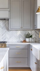 Elegant gray kitchen with herringbone marble backsplash, brass hardware, and white countertops. Modern farmhouse style blends with luxe touches for a chic culinary space.